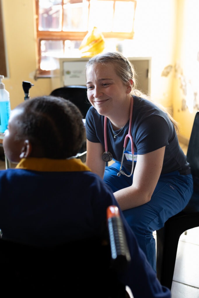 Build the Nations: Medical volunteer conducting a medical examination on a special needs child.
